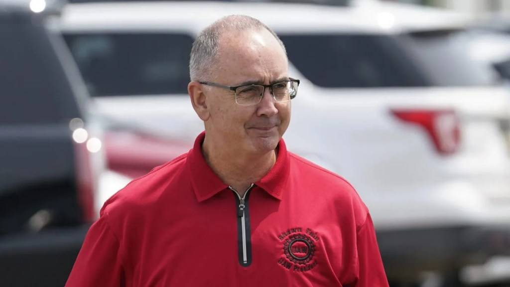 UAW President Shawn Fain | Brimco Uaw president shawn fain wearing a red union shirt at an outdoor union event